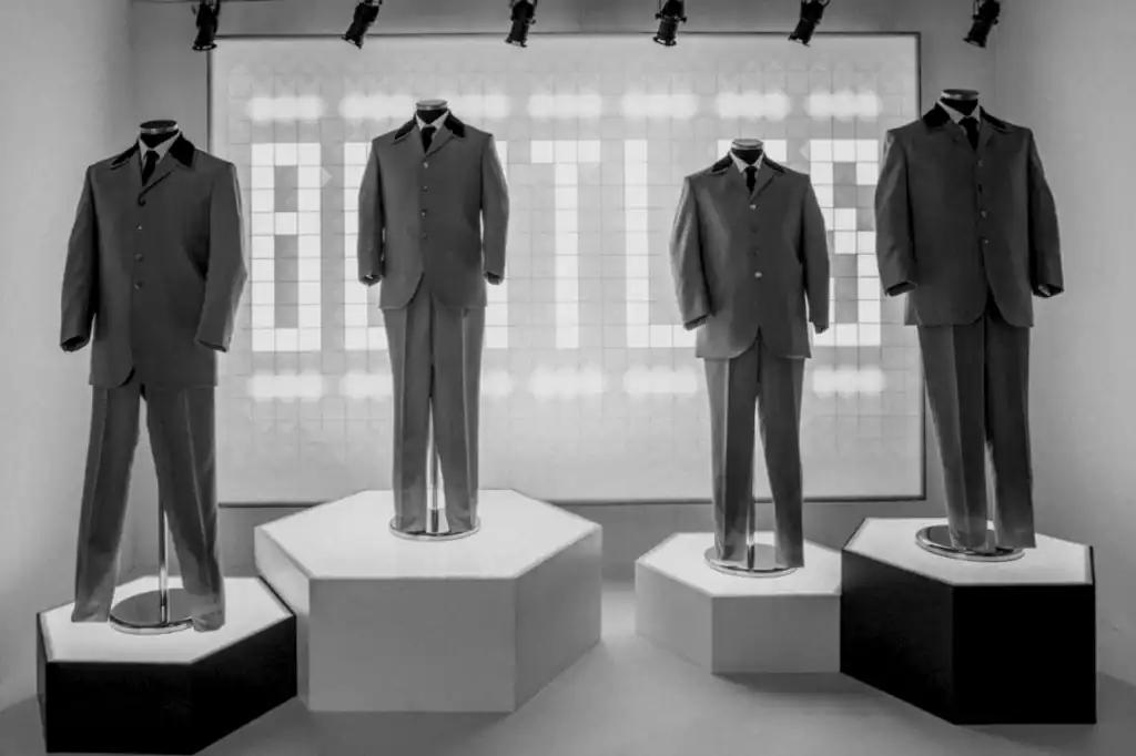 Mannequin figures in black suits on pedestal stands, tied to The Beatles’ era and the notorious stories from George Harrison and John Lennon.