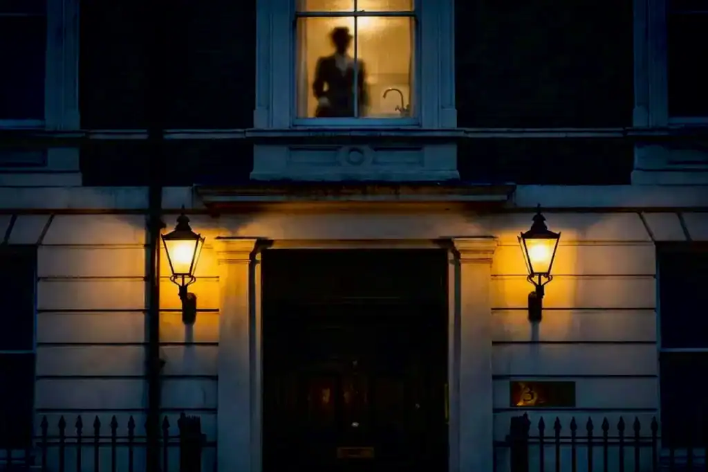 Warm lantern lights glow outside The Langham Hotel, London, beside the Room 333 door, where haunted elevator stories are said to linger.