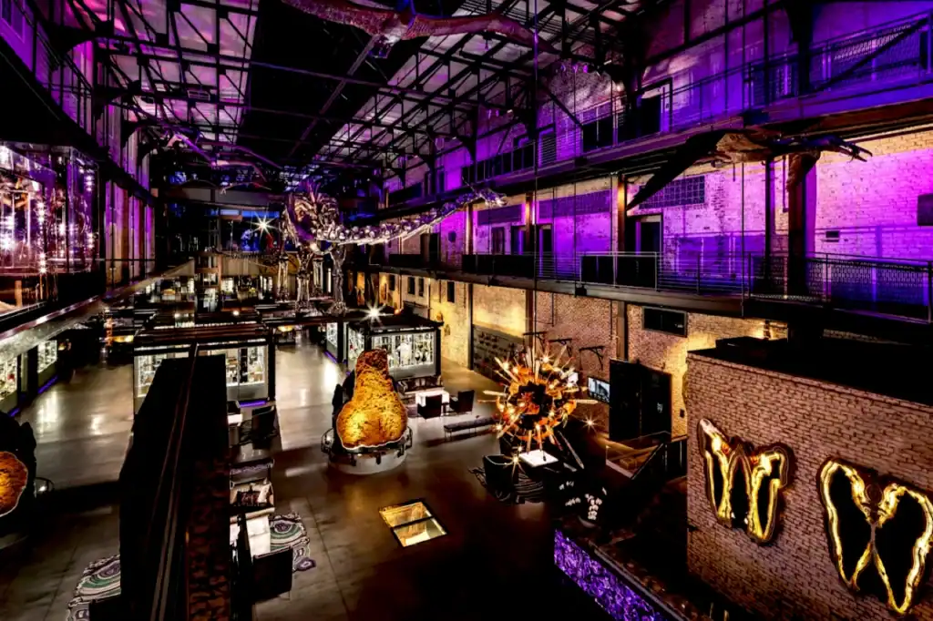 Chrome Miss Chromina Joule, a 135-foot dinosaur skeleton, towers over the purple-lit JW Marriott Savannah Plant Riverside District lobby.