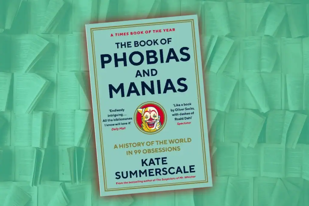 A green-tinted book cover with bold typography reading “The Book of Phobias and Manias” by Kate Summerscale, set among stacked pages.