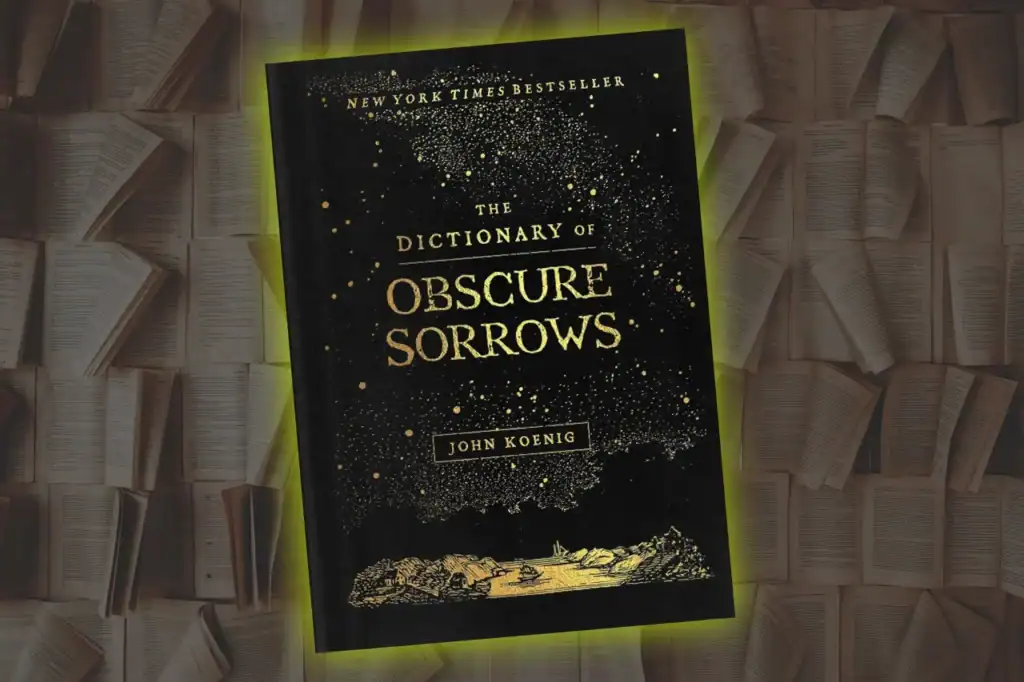 A black and gold cover for The Dictionary of Obscure Sorrows by John Koenig, set among open pages and scattering speckled dots.